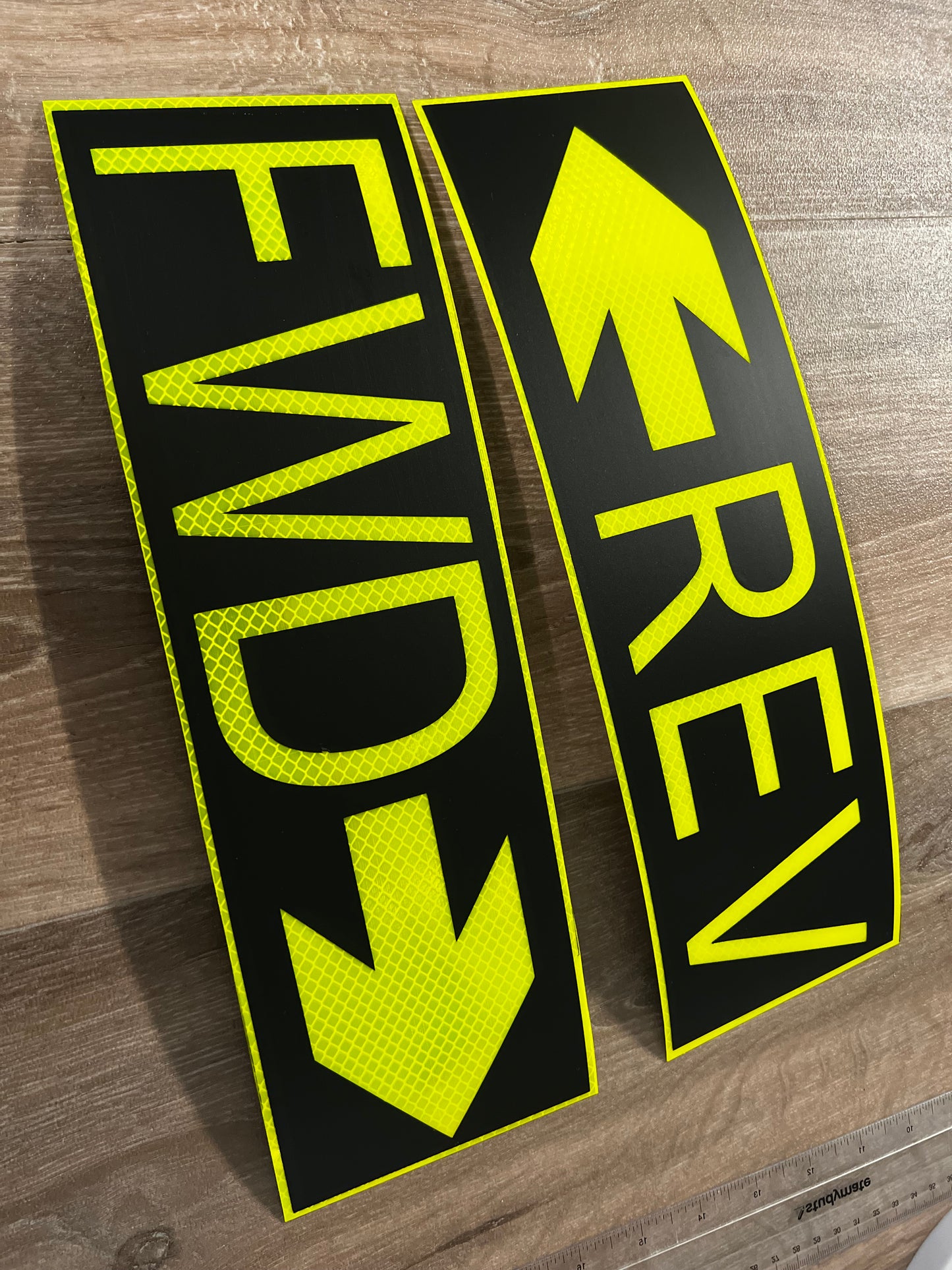 Two reflective stickers with 'REV' and 'FWD' text on